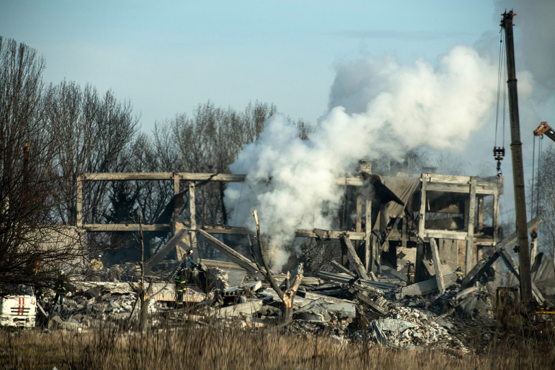 Emergency workers in the rubble of the building destroyed by shelling in Makiivka, in Russian-occupied eastern Ukraine, on Jan. 1.