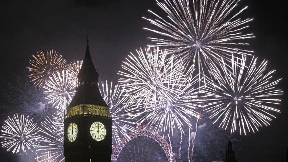 Fireworks explode in the sky as Big Ben strikes midnight in London