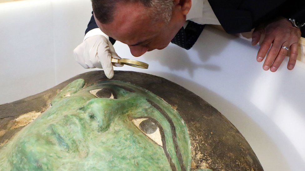 Secretary-General of the Egyptian Supreme Council of Antiquities Mostafa Waziri takes a close look at the ancient Egyptian Green Coffin, after it was returned by the US (2 January 2023)