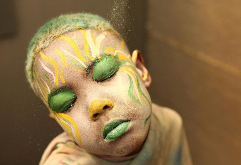 Junior Lambrechts has his face painted in preparation for the Cape Minstrel Carnival in Cape Town, South Africa January 2, 2023