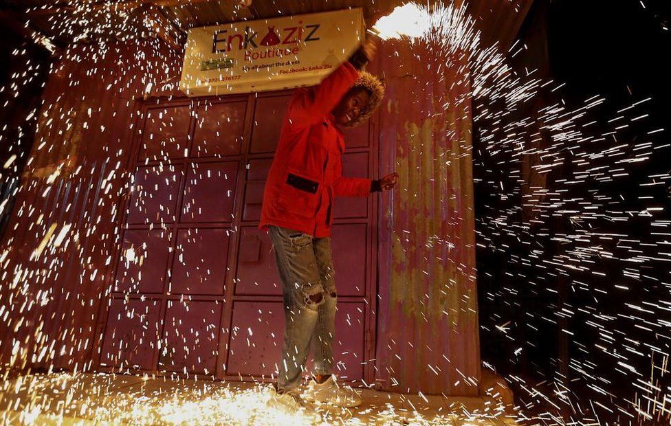 A reveller spins burning-steel wool to spread sparks of fire during the New Year's Eve celebrations in Nairobi, Kenya January 1, 2023
