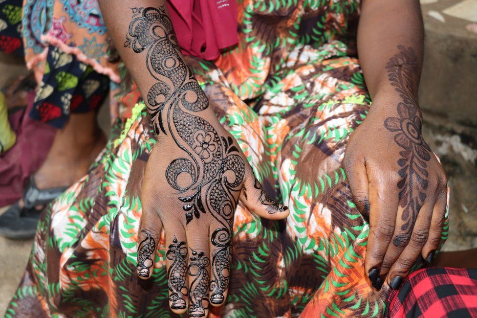 A woman shows her hands painted with henna, in Yaounde, Cameroon on December 30, 2022. Muslims in Cameroon show their happy moments such as weddings, religious holidays, reciters of the Qur'an and hafiz ceremonies with henna paintings applied on their bodies. Henna is made from dried up henna tree leaves, after the leaves turned into powder, water and oil are added; also some plants can be added to the henna applied in this state to obtain different colors upon request