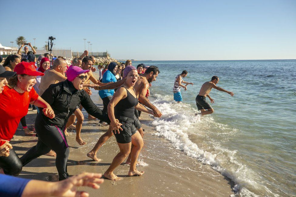 People attend swimming event on the first day of new year as daily life continues in Nabil, Tunisia on January 01, 2023
