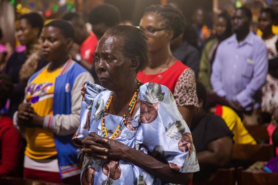 Catholic faithful gather inside the Basilica of the Uganda Martyrs to pray after receiving news about the death of former Pope Emeritus Benedict XVI in Namugongo, Kampala, Uganda, on December 31, 2022