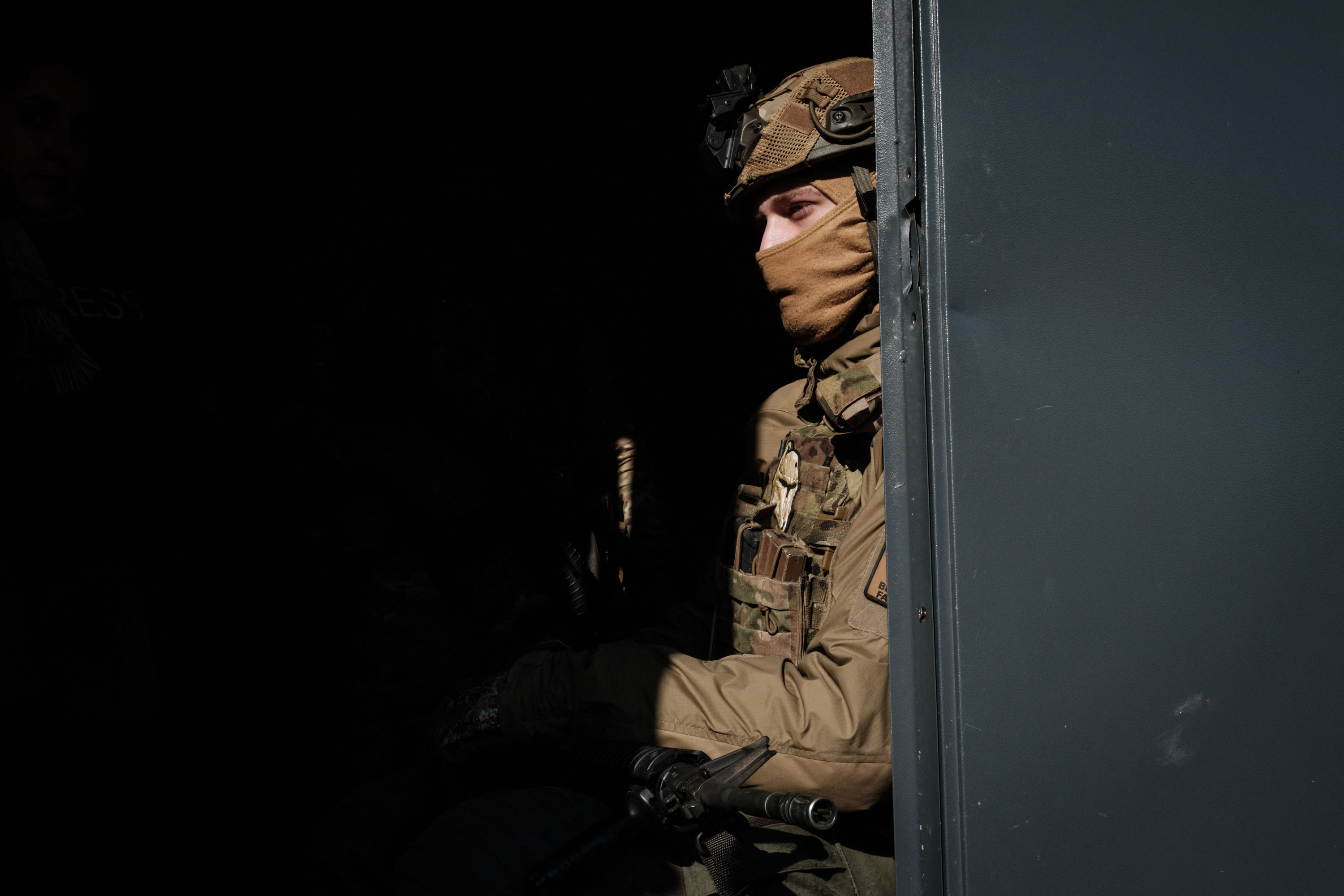 A Ukrainian Army serviceman waits for an order near Bakhmut, on Thursday.