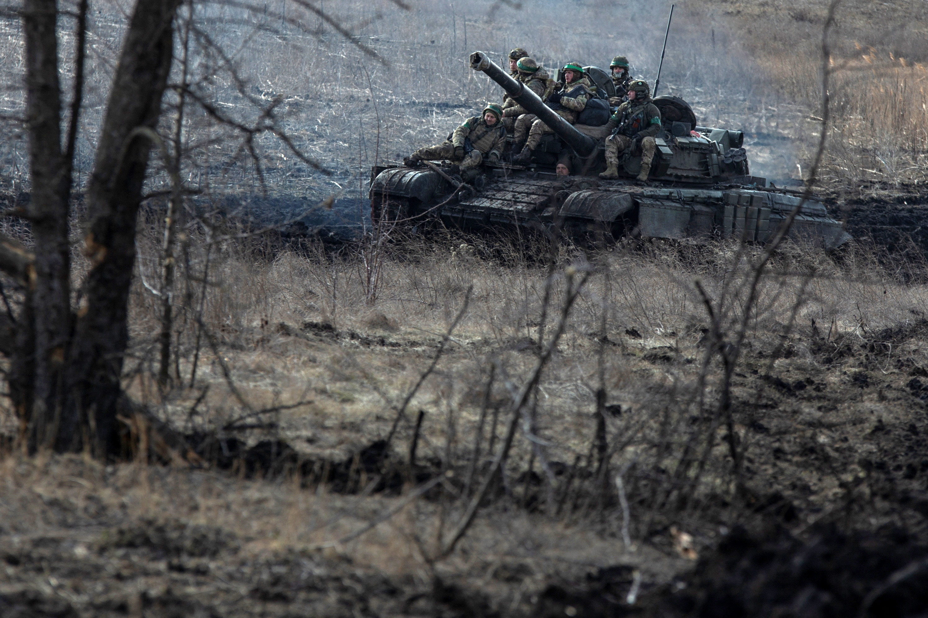 Ukrainian service members ride atop a tank near Bakhmut, Ukraine, on March 4. 