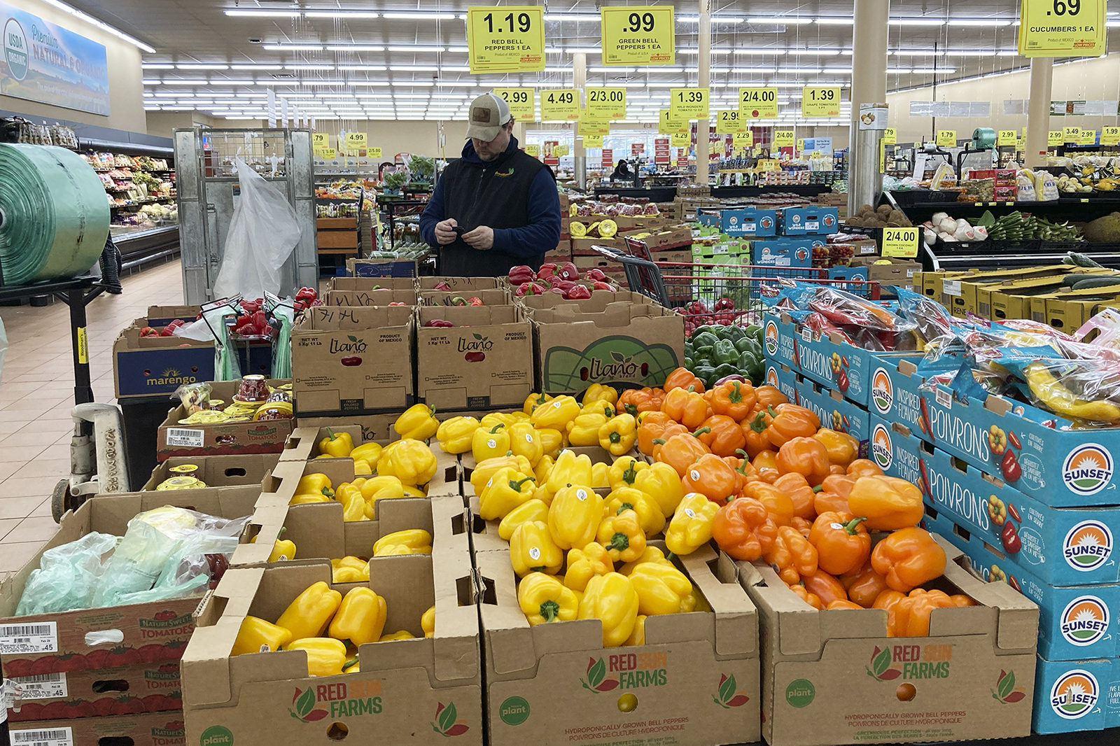 A man looks at his mobile phone while shopping at a grocery store in Buffalo Grove, Ill., on March 19.