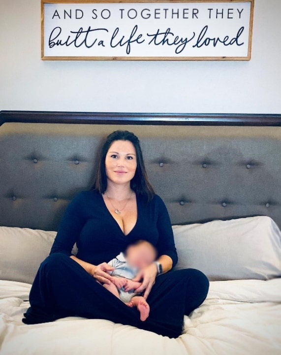 Krystal Talavera sitting on a bed with her baby